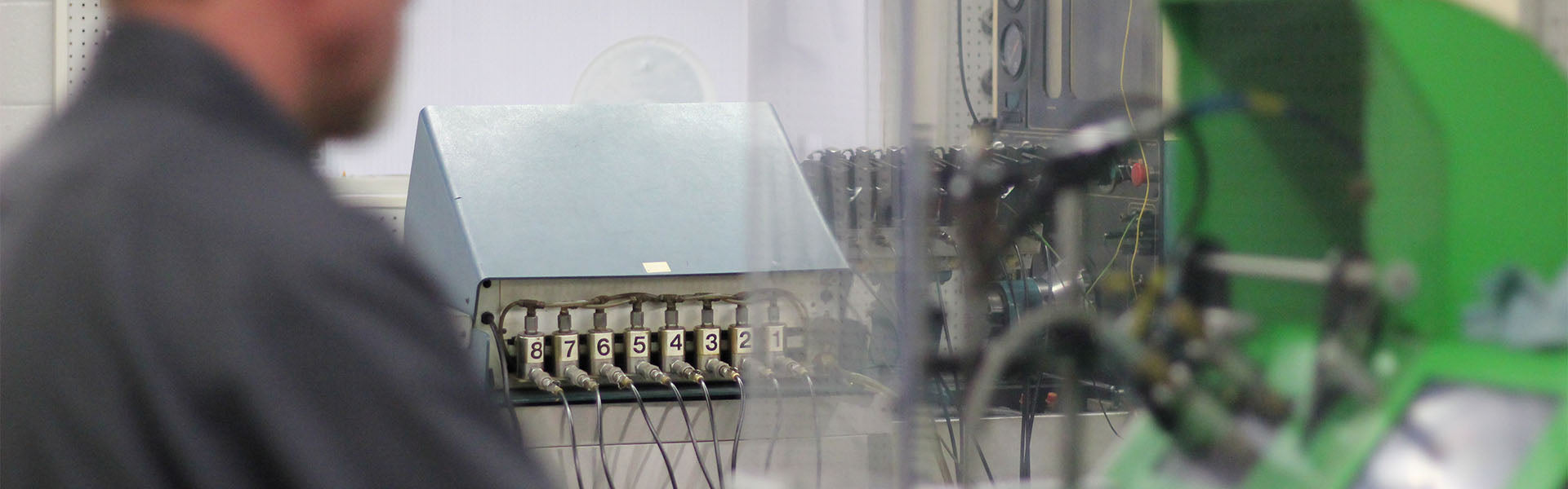 Technician working on testing machines for diesel engine pump